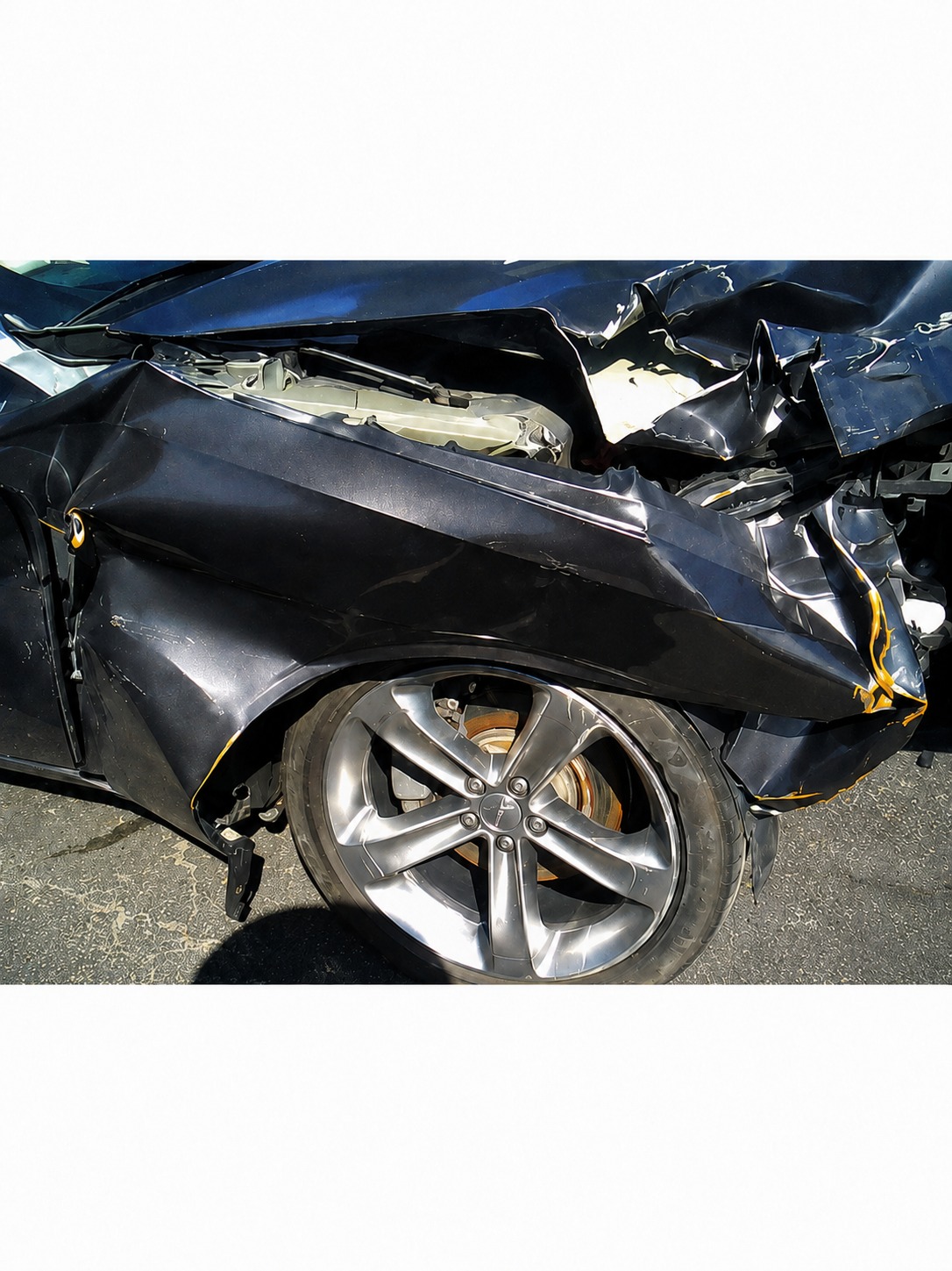 Collision damage to navy Challenger fender