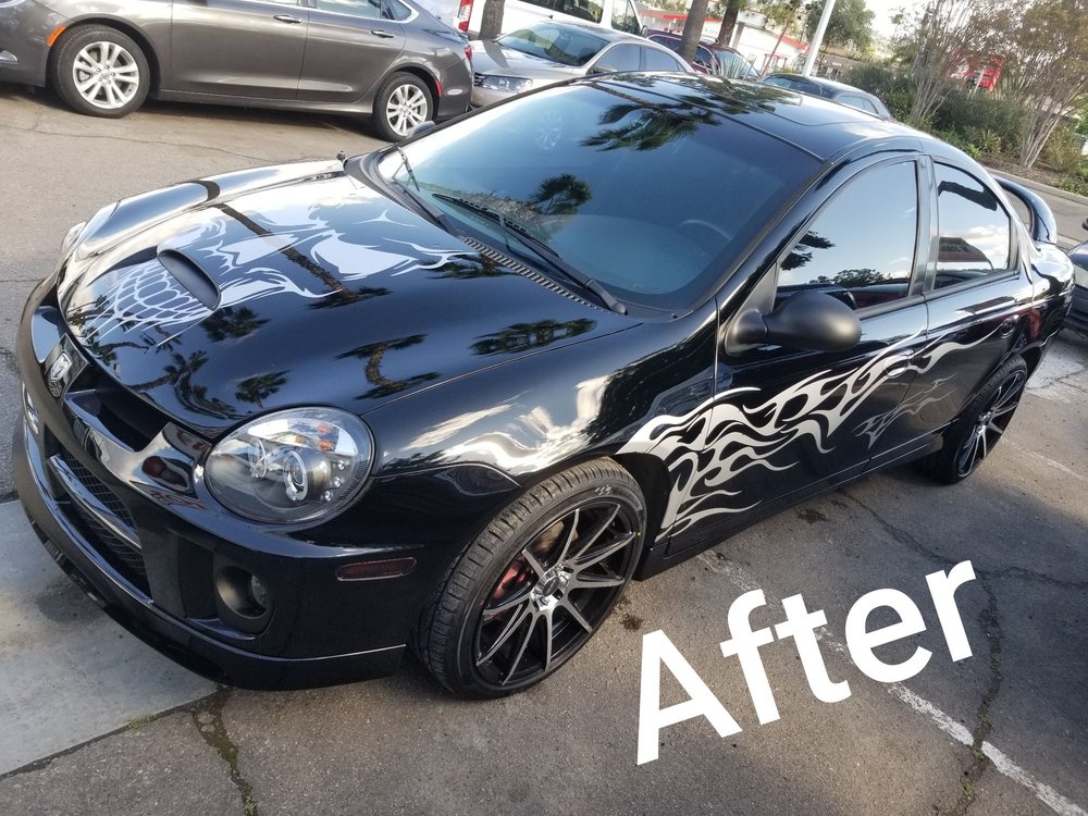 Black sedan with custom flame graphics fully restored - after collision repair