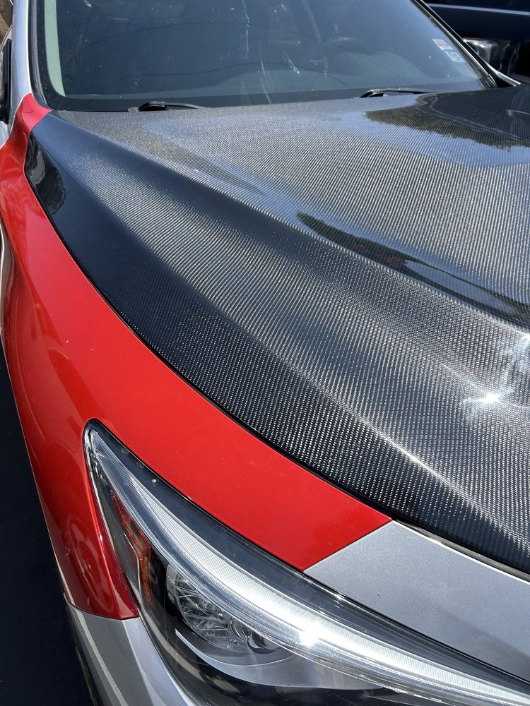 Red vehicle hood with custom carbon fiber finish
